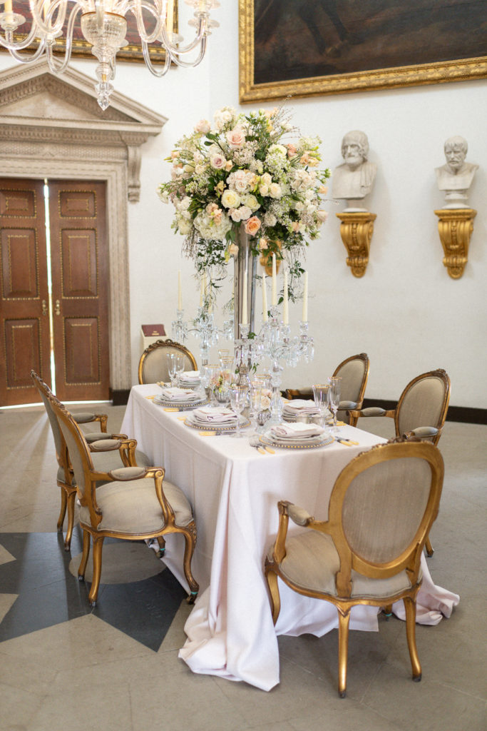 Long Wedding reception table at Chiswick House with tall flower arrangement