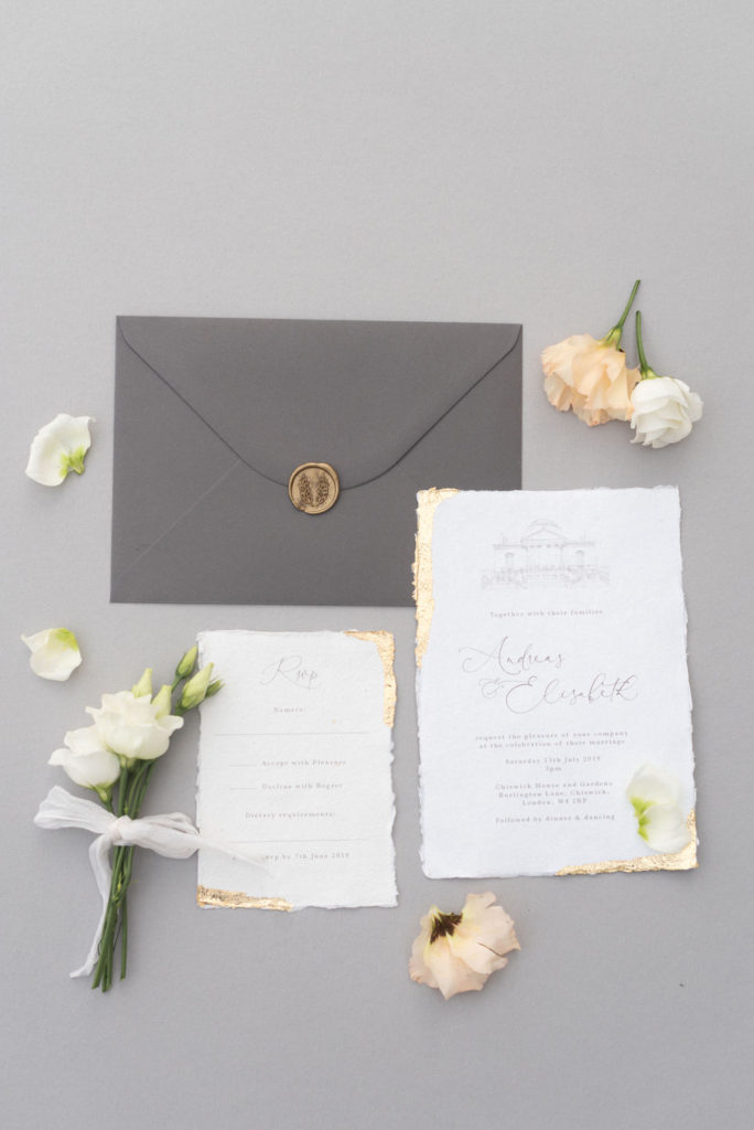 Grey and gold stationery suite flat lay with flowers