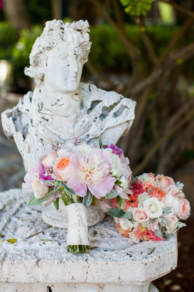 Blush, pink and lilac wedding bouquets displayed on statue