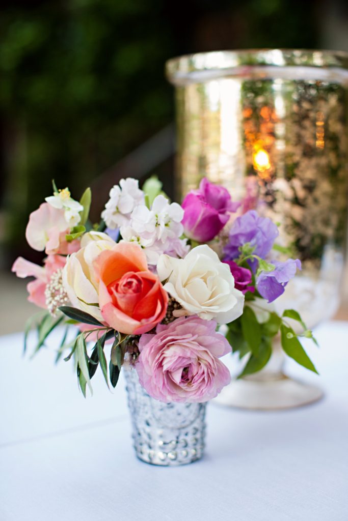 Bud vase with coral and lilac flowers