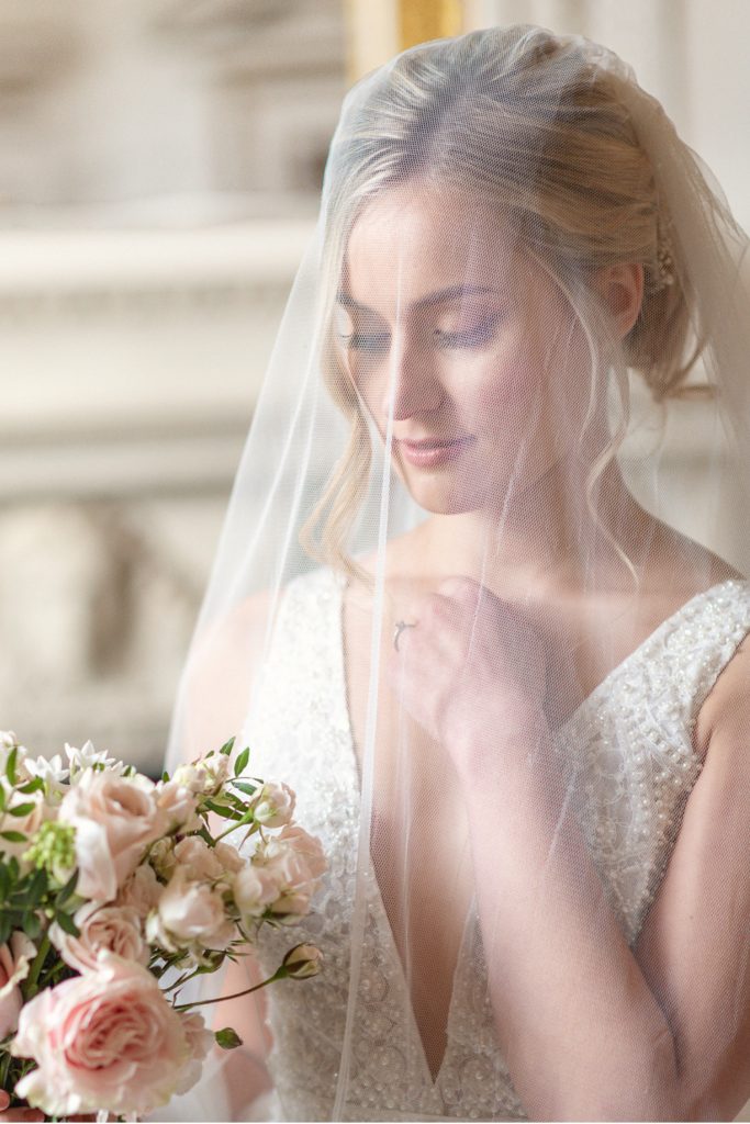 Bride wearing veil and holding bouquet