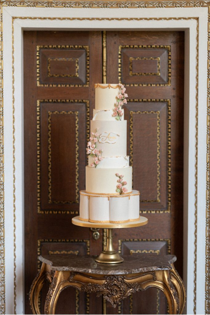 4 tier gol and white wedding cake with sugar flowers