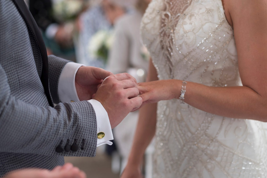 Bride and groom exchanging rings in wedding ceremony