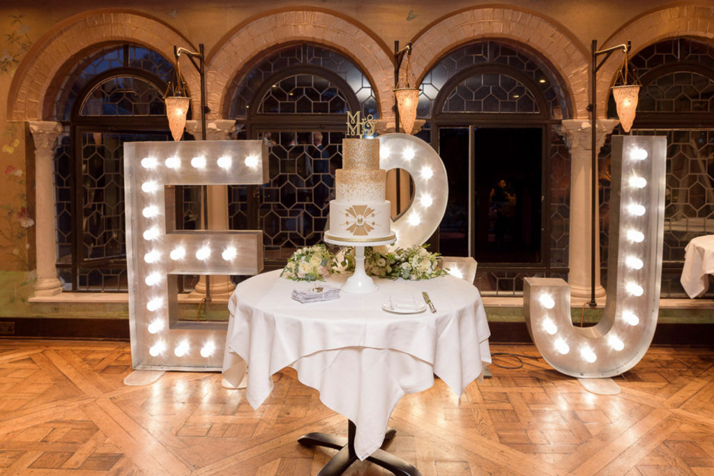 LED light up letters with wedding cake on table