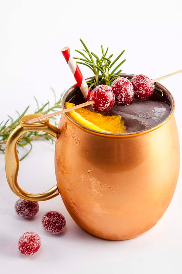 copper mug with cranberry christmas mule cocktail  and sugared cranberries