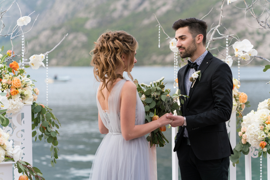 Wedding couple exchanging vows during outdoor ceremony