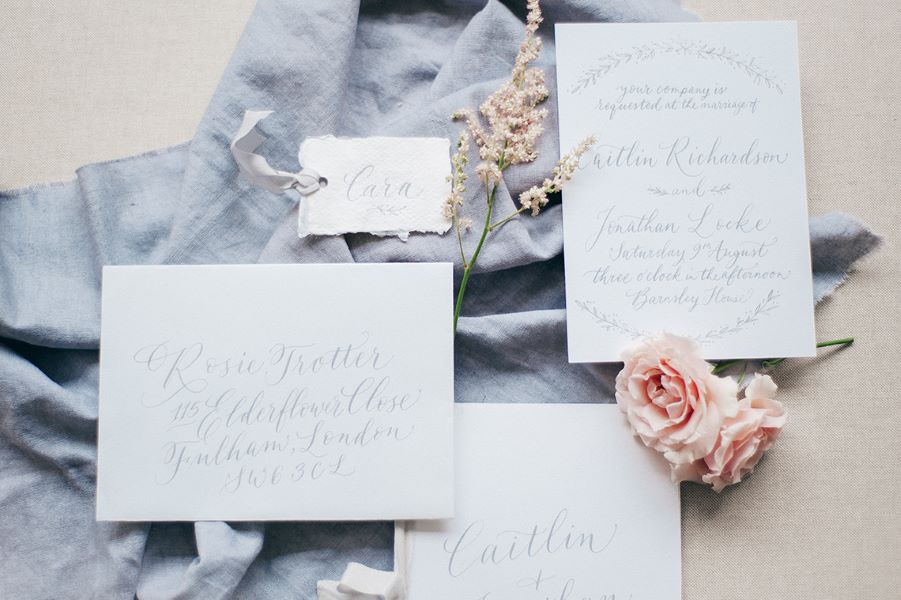 grey and white calligraphy wedding stationery