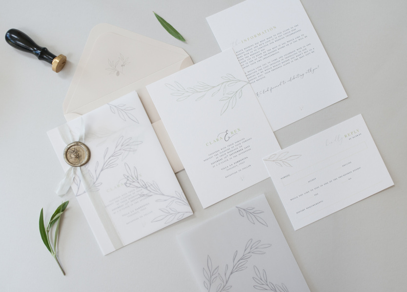 Pale green and white wedding invitations with leaf details