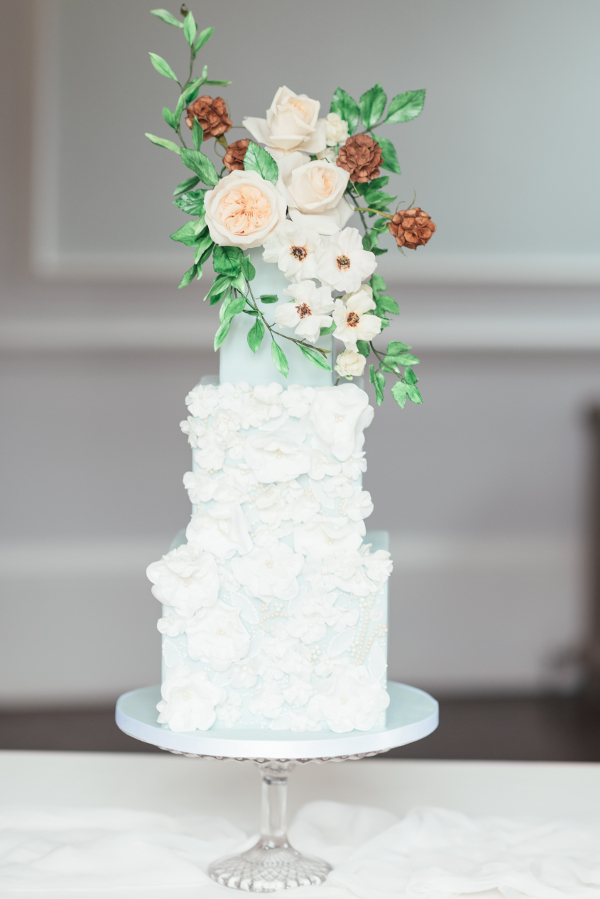 4 tier wedding cake with ruffle texture and fresh flowers