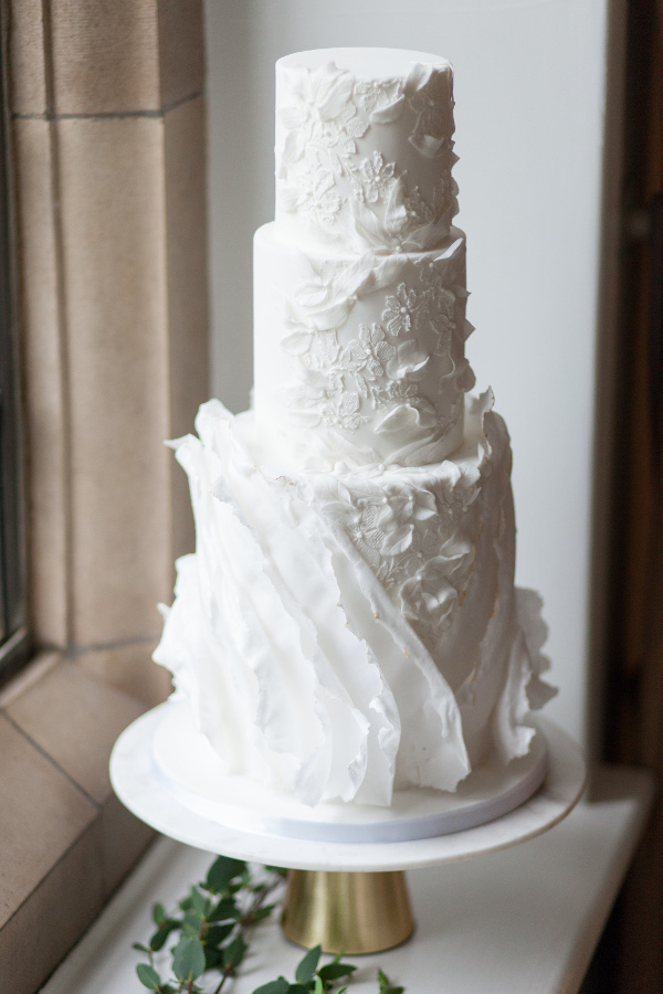 3 tier wedding cake with large ruffle detail in white
