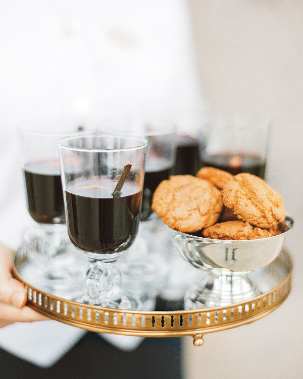 Hot chocolate and biscuits served on a gold rimmed tray 