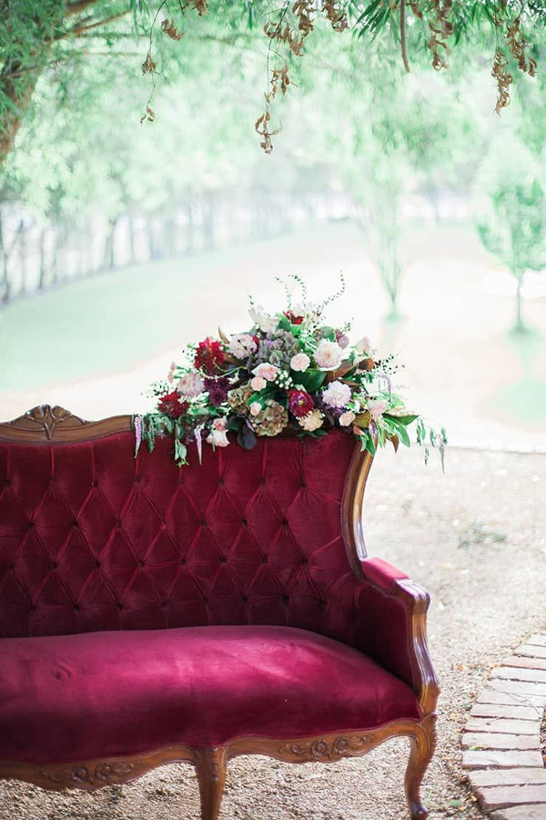 Burgundy vintage sofa at wedding reception
