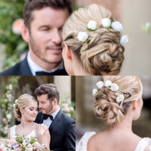 Bridal updo hair style with fake flower clips