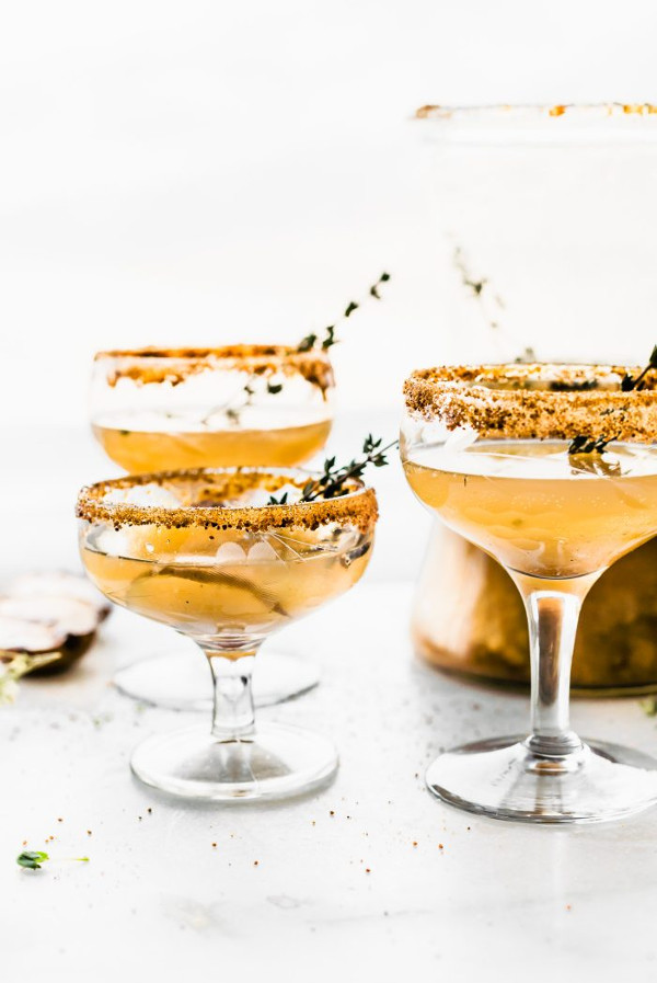 Pear cocktail in coupe glass with gold glitter rim decoration