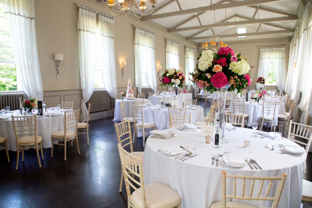 Wedding reception at Morden Hall with pink and white tall and low centrepieces