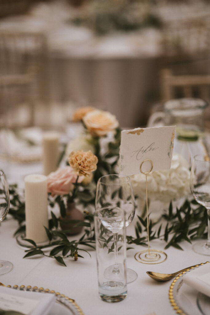 Gold table setting with candles and blush flowers