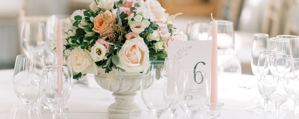 Blush pink wedding flower centrepiece with table number