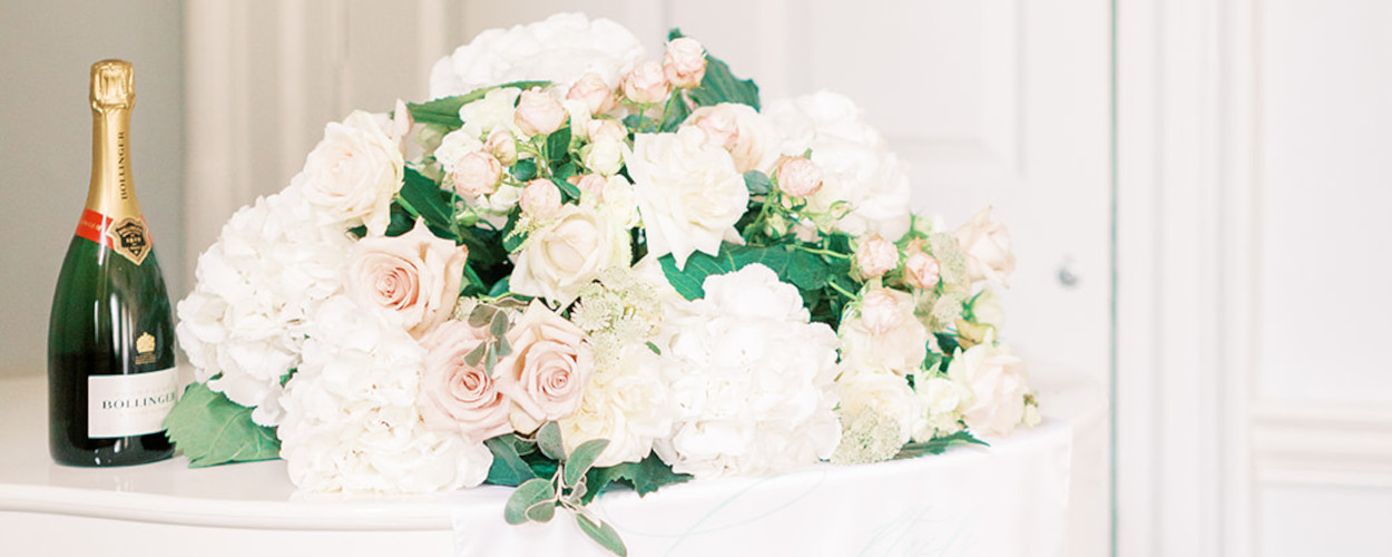 Blush and white flowers with fabric bar sign at Morden Hall