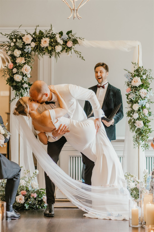 Bride and groom kiss and dip at Morden Hall wedding ceremony