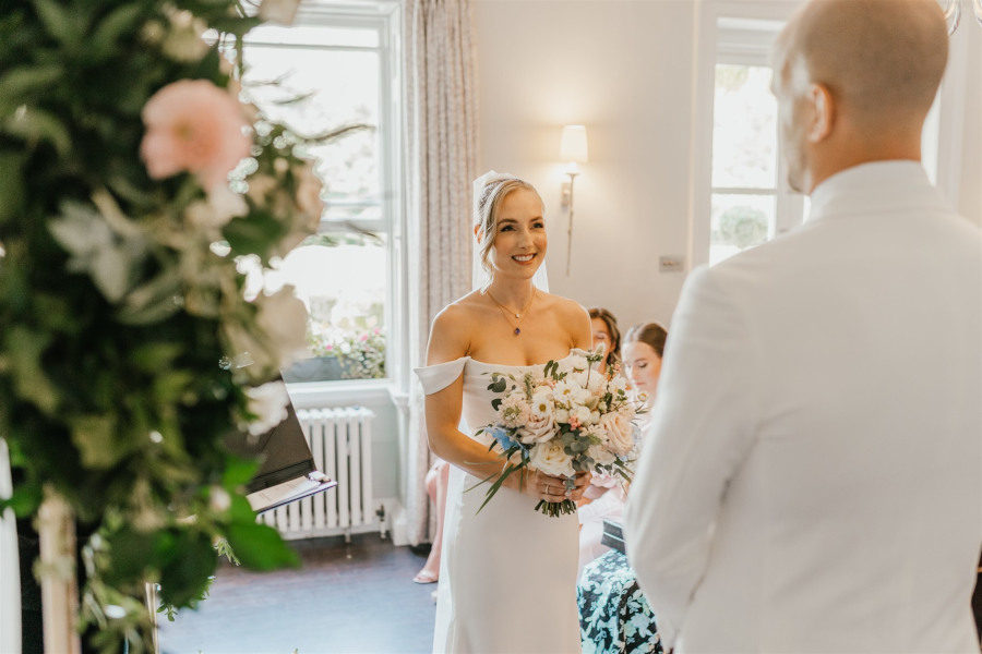 Bride and groom in wedding ceremony at Morden Hall