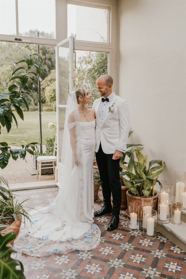 Bride and groom in Orangery at Morden Hall with hurricane candles