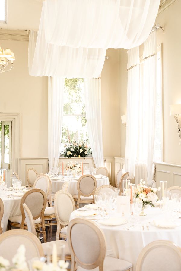 Wedding reception at morden hall with draping and lemon blush flowers