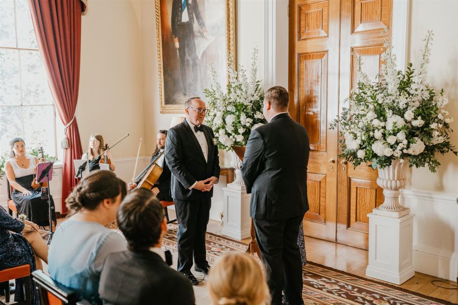 Two grooms wedding ceremony with flowers trnity house
