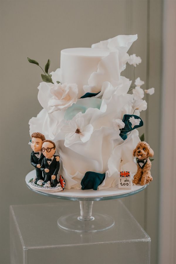 Ruffle wedding cake with grroms and dog cake toppers trinity house