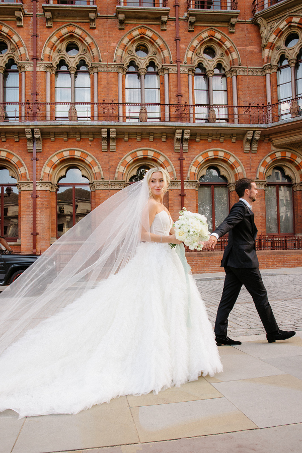 Couple walking past st pancras hotel London